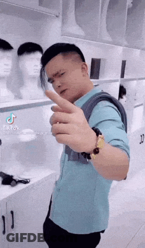 Man In Blue Shirt Makes Funny Face By Wig Display GIF