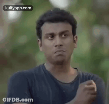 Man In Blue Shirt Making Funny Face And Fist GIF