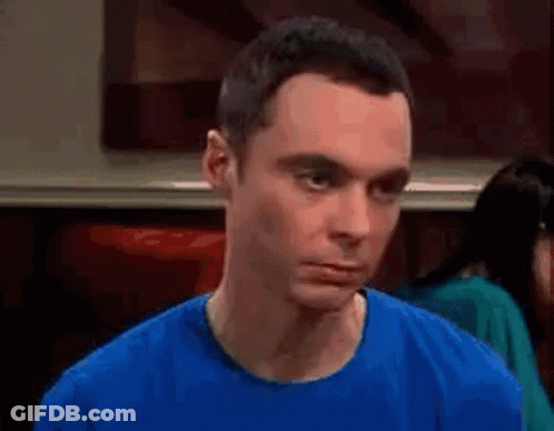 Man In Blue Shirt Making Funny Face At Table GIF