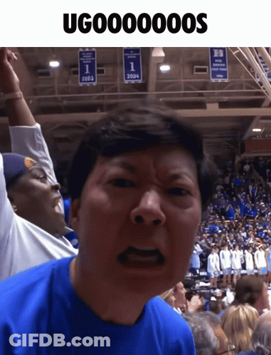Man In Blue Shirt Making Funny Face In Front Of 2003 Banner GIF