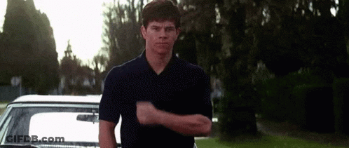 Man In Blue Shirt Making Funny Face In Front Of Car GIF