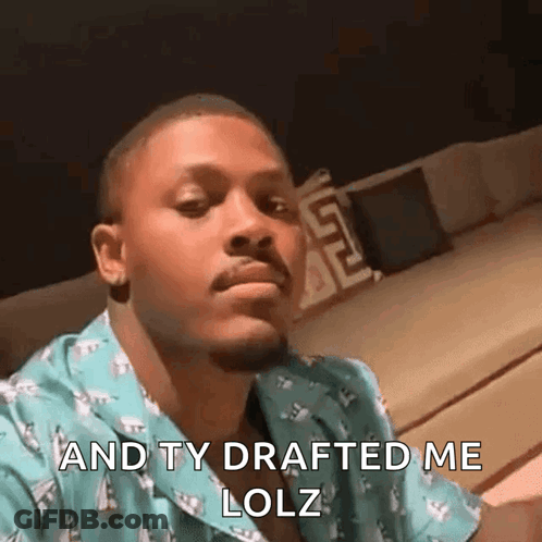 Man In Blue Shirt Making Funny Face On Couch GIF