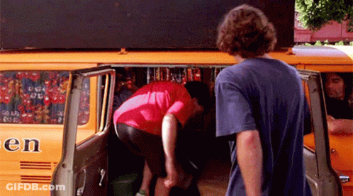 Man In Blue Shirt Next To Orange Van Saying En GIF