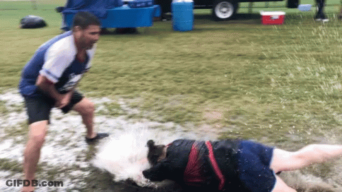 Man In Blue Shirt Next To Woman In Muddy Field GIF