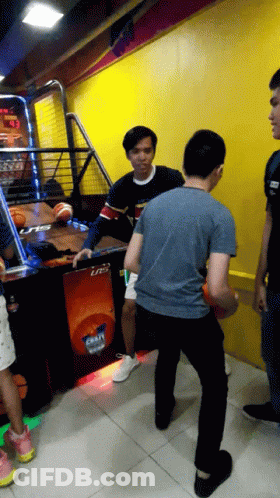 Man In Blue Shirt Playing Basketball With Machine Saying Lrts GIF