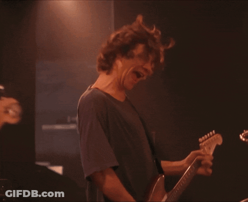 Man In Blue Shirt Playing Bass Guitar GIF