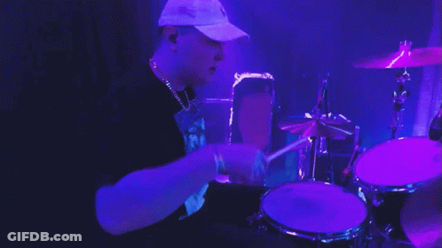 Man In Blue Shirt Playing Drum Saying Narayanan GIF