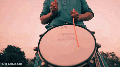 Man In Blue Shirt Playing Drum Saying Narayanan GIF