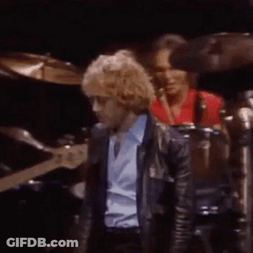 Man In Blue Shirt Playing Guitar, Man In Red Shirt Playing Drum GIF