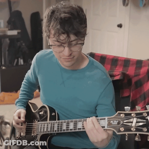 Man In Blue Shirt Playing Guitar GIF