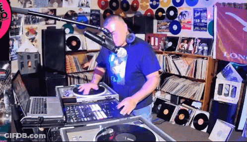 Man In Blue Shirt Playing Music At Mic Saying Long GIF