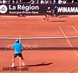 Man In Blue Shirt Playing Tennis With La Region Sign GIF