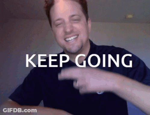 Man In Blue Shirt Pointing At Keep Going GIF