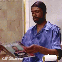 Man In Blue Shirt Reading Angry Blackman Magazine GIF