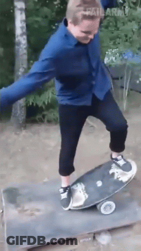 Man In Blue Shirt Riding Skateboard GIF