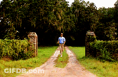 Man In Blue Shirt Running Down Dirt Path GIF