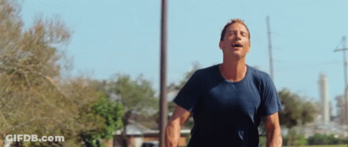 Man In Blue Shirt Running Eyes Closed GIF