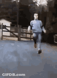 Man In Blue Shirt Running GIF