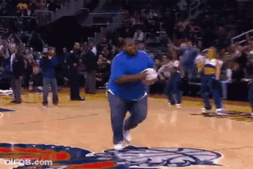 Man In Blue Shirt Running On Basketball Court In Front Of Crowd GIF