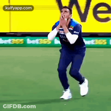 Man In Blue Shirt Running On Green Field GIF