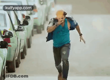 Man In Blue Shirt Running With Bottle GIF