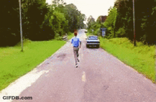 Man In Blue Shirt Running With Car GIF