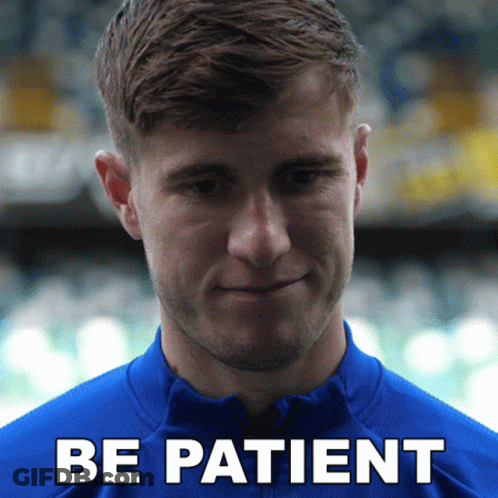 Man In Blue Shirt Saying Be Patient GIF