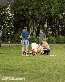 Man In Blue Shirt Saying Georgia In Field With People GIF