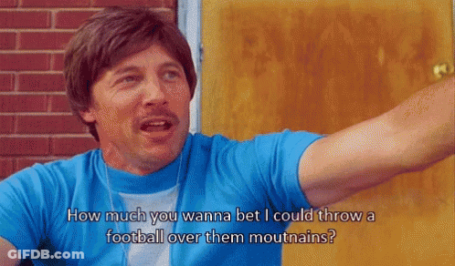Man In Blue Shirt Saying How Much You Wanna Bet I Could Throw A Football Over Them Mouthains GIF