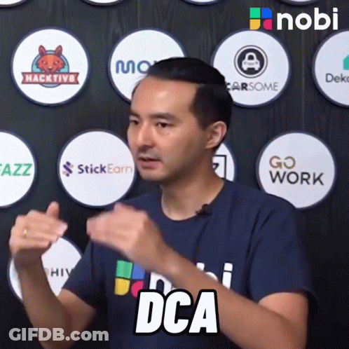 Man In Blue Shirt Says DCA In Front Of Logos GIF