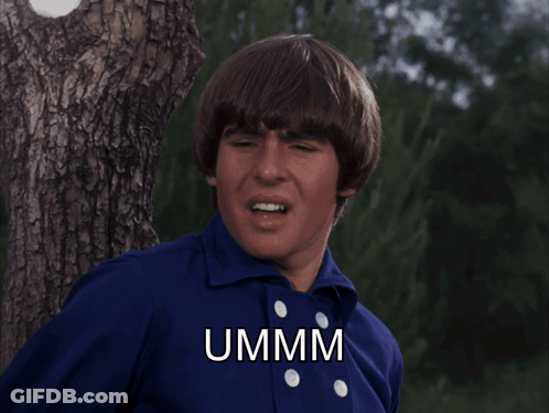 Man In Blue Shirt Says Ummm Beside Tree GIF