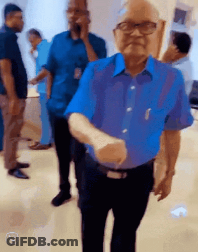 Man In Blue Shirt Shaking Hands GIF