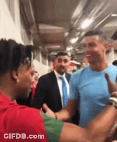 Man In Blue Shirt Shaking Hands GIF