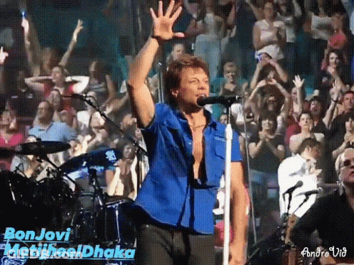 Man In Blue Shirt Singing Bon Jovi Into Microphone GIF