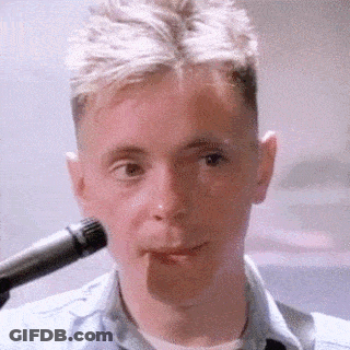 Man In Blue Shirt Singing Into Microphone GIF