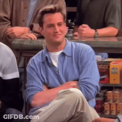 Man In Blue Shirt Sitting At Bar With Arms Crossed GIF
