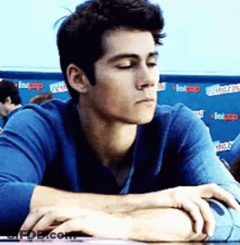 Man In Blue Shirt Sitting At Table GIF