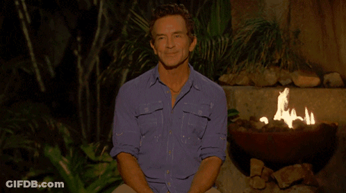 Man In Blue Shirt Sitting By Fire Pit GIF