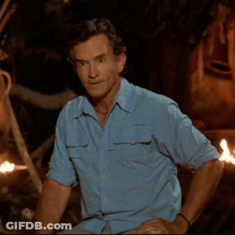 Man In Blue Shirt Sitting By Fire GIF