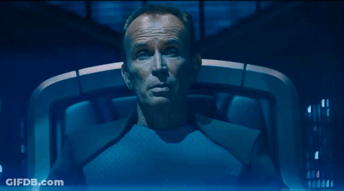 Man In Blue Shirt Sitting Eyes Closed Saying Well GIF