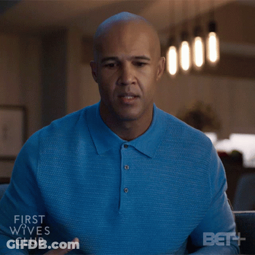 Man In Blue Shirt Sitting In Front Of First Wives Club Screen GIF
