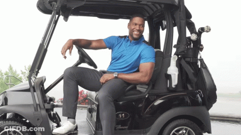 Man In Blue Shirt Sitting In Golf Cart Number 11 GIF