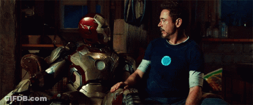 Man In Blue Shirt Sitting Next To Man In Suit GIF
