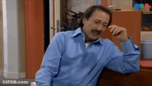 Man In Blue Shirt Sitting On Couch GIF