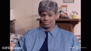 Man In Blue Shirt Sitting On Couch With Comedy Central Logo GIF