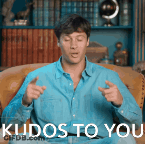 Man In Blue Shirt Sitting On Couch With Kudos To You GIF