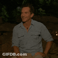 Man In Blue Shirt Sitting With Hands On Knees GIF