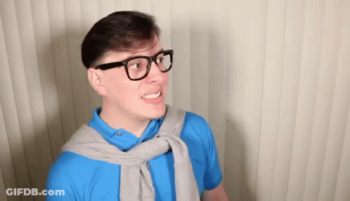 Man In Blue Shirt Smiling And Making A Face GIF