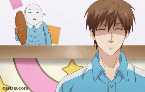 Man In Blue Shirt Smiling In Front Of Cartoon Character GIF