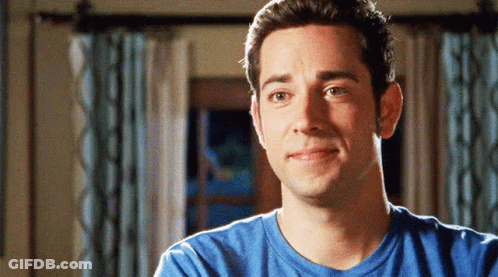 Man In Blue Shirt Smiling In Front Of Window GIF